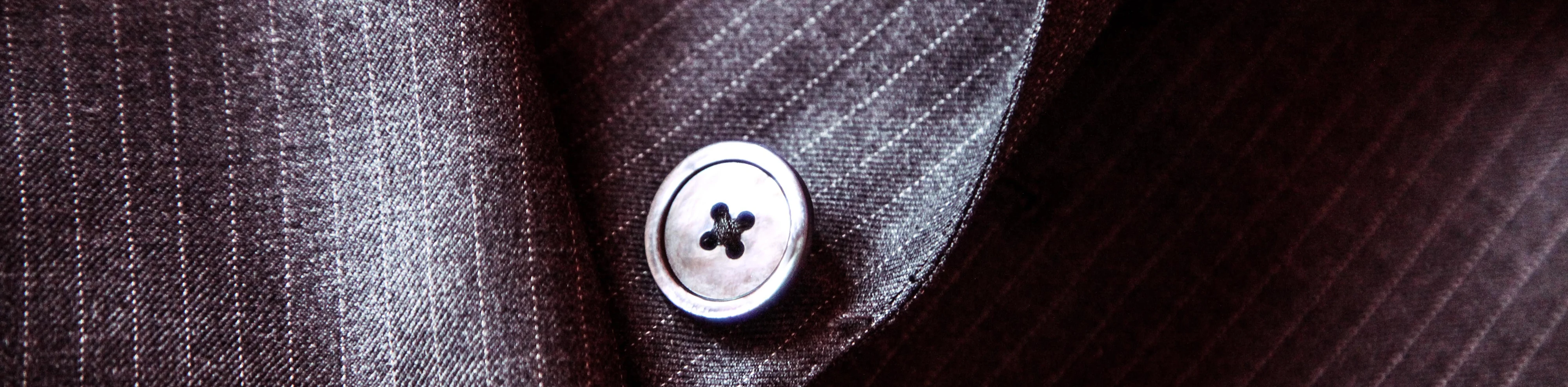 Close-up of a pinstripe suit jacket button